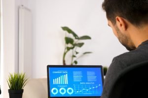 business person working on his laptop looking at chart data